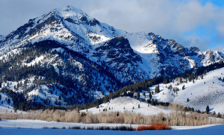 Snowy mountain range trees clouds - a snowy mountain range free wallpaper