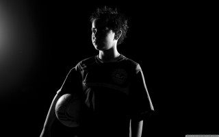 Young man soccer ball dark - a spotlight free wallpaper