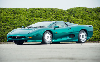 Green sports car parked bushes - a green sports car free wallpaper