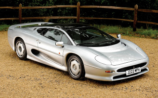 Silver sports car parked gravel - a wooden fence free wallpaper