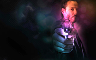 Man holding gun blurry background 2 - vfx free wallpaper