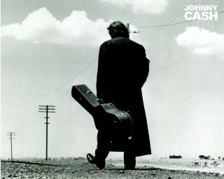 Man holding guitar case right - a gravel road free wallpaper