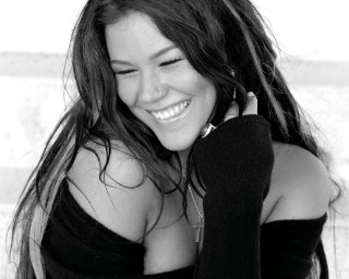 Smiling woman black sweater necklace - amelia peláez free wallpaper