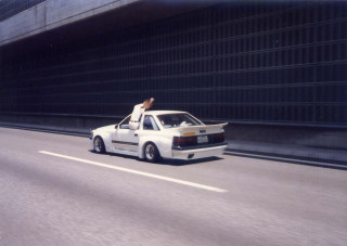 Man sitting car highway building - a highway free wallpaper