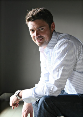 Man sitting chair hand hip 2 - dan scott free wallpaper