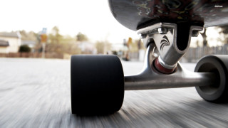 Skateboarder riding street black tire 2 - helmet free wallpaper