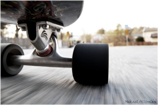 Skateboarder riding street black tire - a street free wallpaper