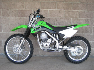 Green dirtbike brickwall sidewalk blacktire - a computer rendering free wallpaper