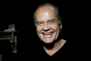 Smiling man dark chair light - donald roller wilson free wallpaper