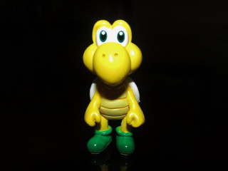 Yellow toy green boot pokemon - a black surface free wallpaper