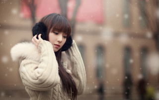 Woman white sweater fur ball - her hand and a building in the background free wallpaper