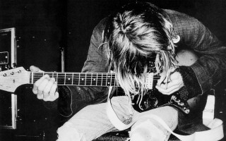 Man long hair playing guitar 3 - a guitar in a room free wallpaper