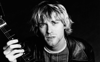 Man holding guitar serious look 2 - a guitar free wallpaper