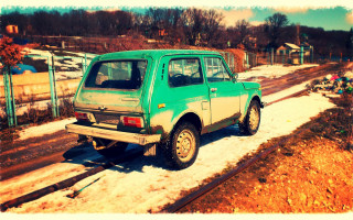 Small green car snowy road - a fence free wallpaper