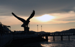 Bird flying water sunset bridge - an art deco sculpture free wallpaper