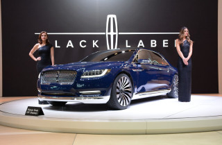 Two women blue car showroom - promotional image free wallpaper