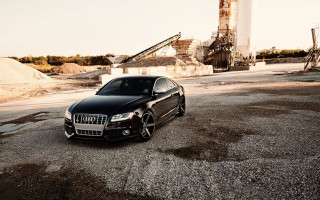 Black car parking lot dirt - a crane in the background free wallpaper
