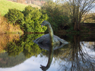 Dinosaur statue lake trees hill - the middle of a lake free wallpaper