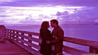Man woman kissing pier water - movie still frame free wallpaper