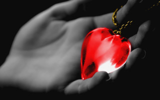 Person holding red heart chains - a red heart free wallpaper