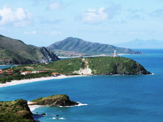 Beach lighthouse hill blue sky - a blue sky and ocean in the background free wallpaper