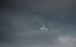 Plane flying dark sky clouds - f 8 aperture free wallpaper