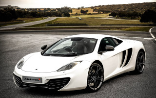 White sports car hill road - a grassy area in the background free wallpaper