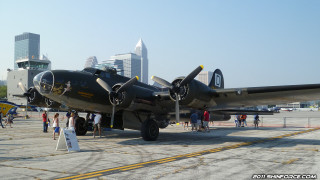 Large propeller plane tarmac city - a city skyline free wallpaper
