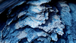 Blue black textured material closeup - a black border free wallpaper