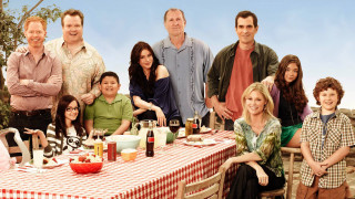 Group people sitting table food 2 - a man in the middle free wallpaper