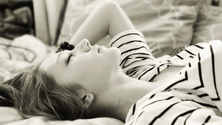 Woman laying bed eyes closed 3 - a bed free wallpaper