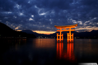 Large orange structure lake cloudy - top of a lake under a cloudy sky free wallpaper