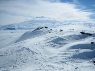 Snow covered mountain sky clouds - ski free wallpaper