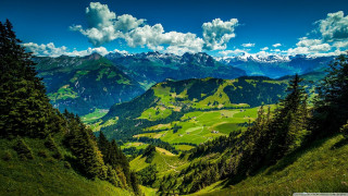 Scenic view valley mountains clouds - a scenic view of a valley free wallpaper
