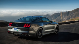 Gray mustang parked mountain road - a view of the mountains free wallpaper