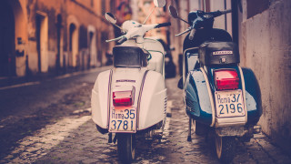 Mopeds parked cobblestone street city - international typographic style free wallpaper for desktop