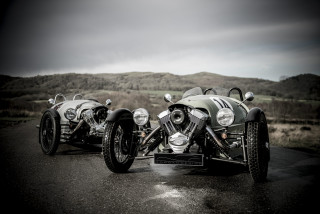 Motorcycles parked road hillside cloudy - a cloudy sky in the background free wallpaper