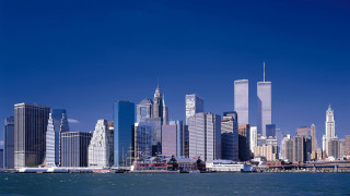 City skyline tall buildings water - a boat in the foreground free wallpaper