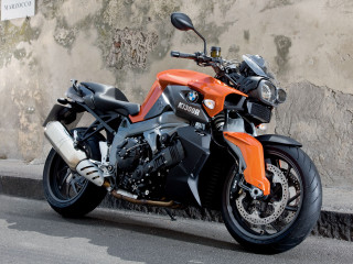 Motorcycle parked road cement wall - a motorcycle free wallpaper