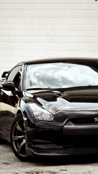 Black car white wall building - a black car free wallpaper