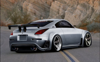 Silver sports car mountain range 2 - the side of a road near a mountain range free wallpaper
