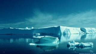 Large iceberg floating ocean distant - the water free wallpaper