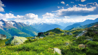 Grassy field mountains clouds sky - a grassy field free wallpaper