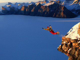 Man jumping cliff water snow - a mountain top free wallpaper
