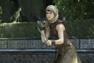Woman costume sword serious look 2 - a costume holding free wallpaper
