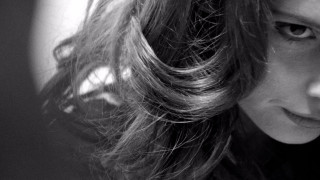 Woman long hair serious look 4 - messy free wallpaper