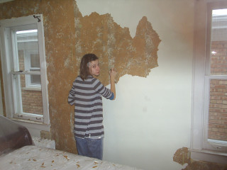 Young boy painting wall brick - a young boy free wallpaper