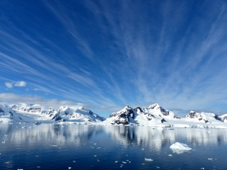 Snowy mountains ocean blue sky - a large body of water free wallpaper