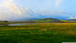 Field lake mountains clouds sky - a lake and mountains free wallpaper