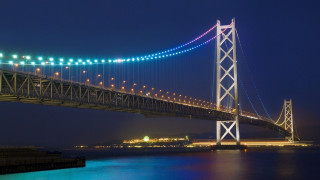 Large bridge night water city - side and a city in the background free wallpaper
